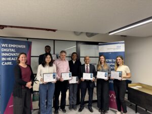 Several people standing in a line holding certificates.